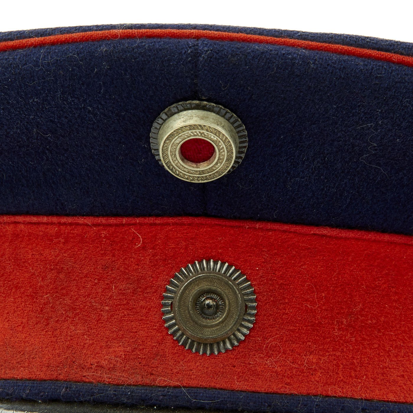 An Imperial German officer visor cap for Prussian Regiments, Dark blue cap  body, red band, red piping, black visor, officer Prussian and national  cockades, brown leather sweatband with fine white silk lining.